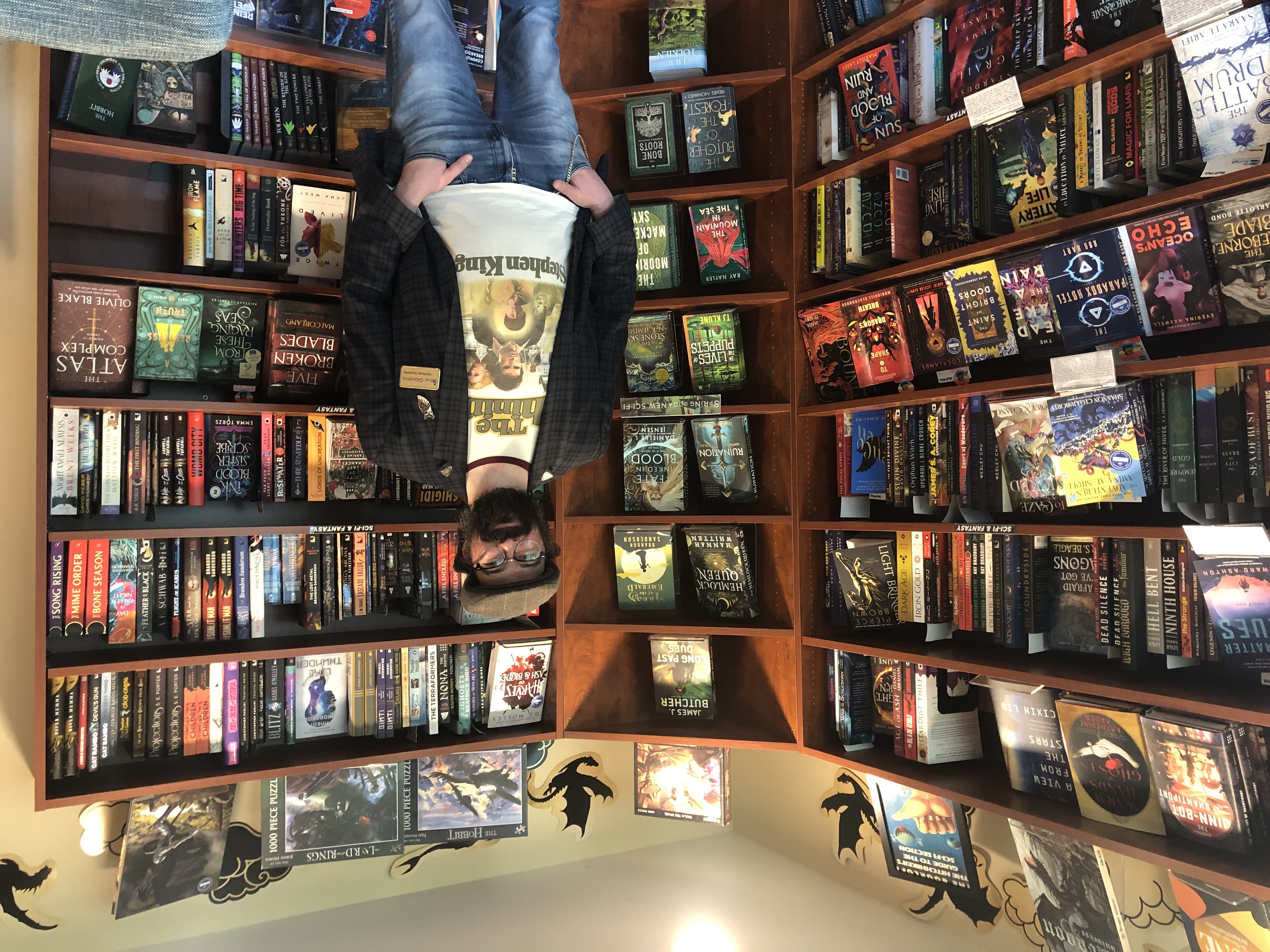 The Bookloft owner, Giovanni Boivin, stands in front of a bookshelf.